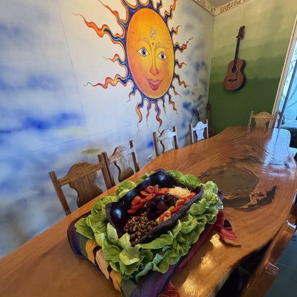 Locally sourced meal served at the hand-carved wooden dining table