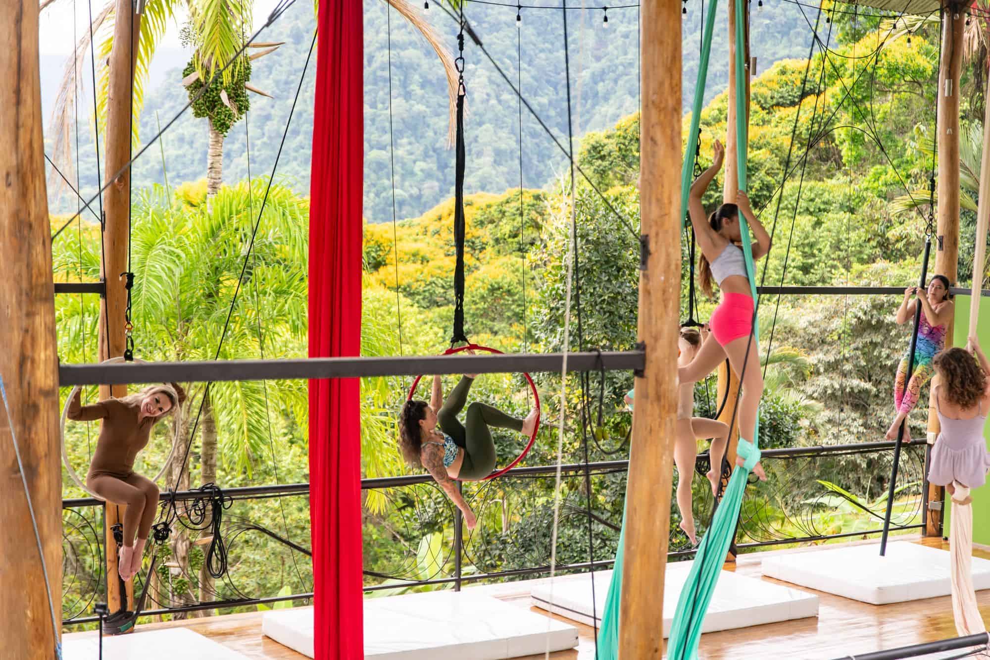 The open-air circus training studio with silks rigged above the jungle valley at Airborne Arts Costa Rica