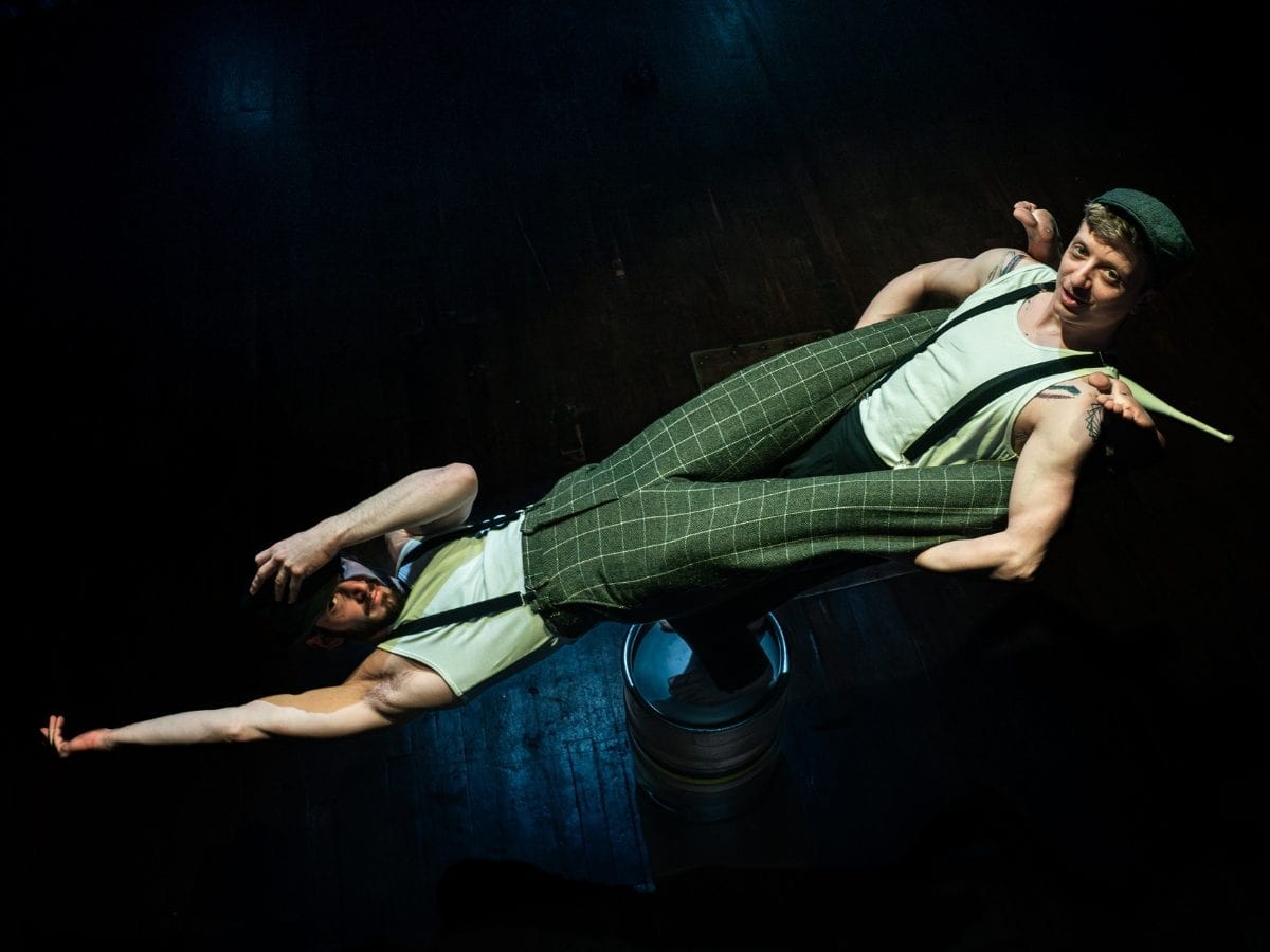 Toffy Paulweber and Jared Shanks performing partner acrobatics on stage